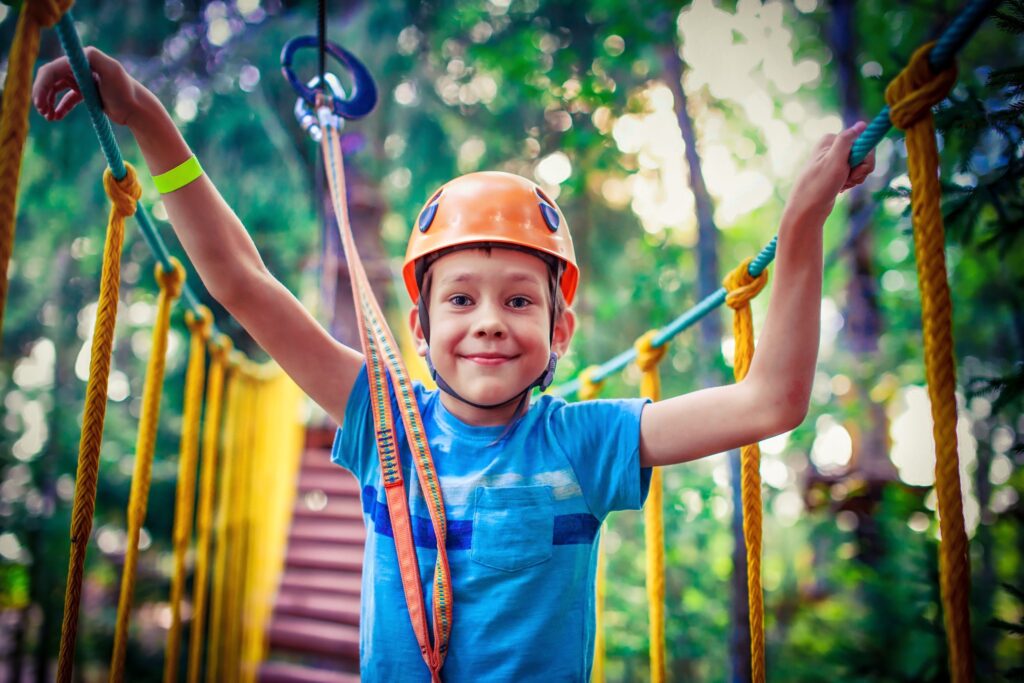 happy boy on the zip line. proud of his courage the child in the