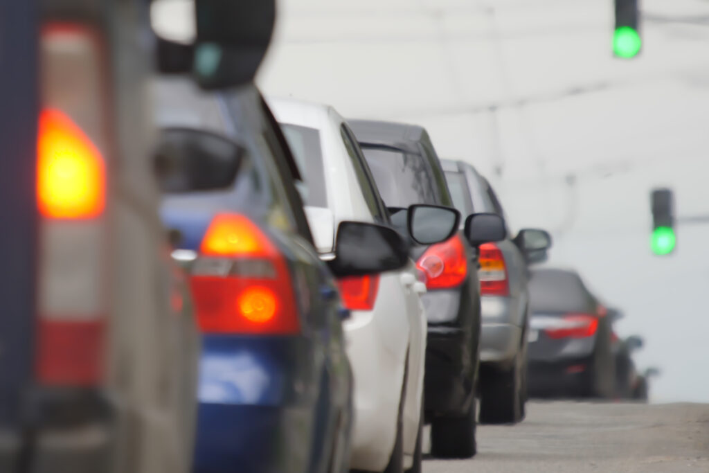 Blur background road city congestion in rush hour car traffic day. Blurred road car congestion traffic background city defocus. Rush hour traffic jam. Crowded cars moving slowly on road busy city blur